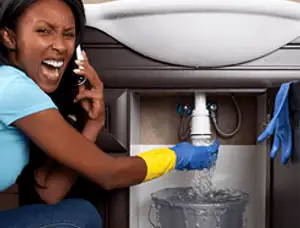 Emergency plumbing repair for a leaking sink drain under a bathroom vanity in Chico, CA