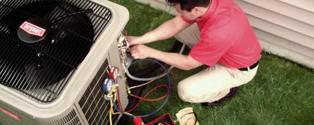 HVAC technician servicing an outdoor air conditioner unit in Chico, CA