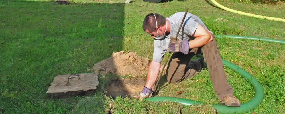 Septic pumping technician servicing a residential septic tank in Chico, CA