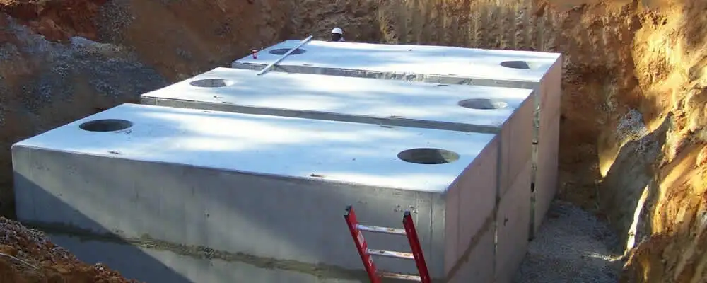 Septic tank installation site with a newly placed concrete tank in Chico, CA